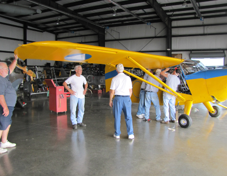 Volunteers working on the Stinson during assembly