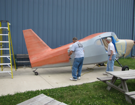 The bare Stinson fuselage on its stand