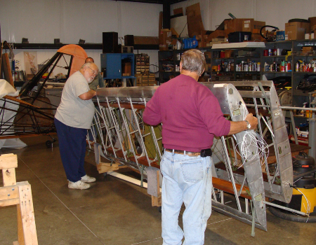 Volunteer inspecting the wing prior to covering
